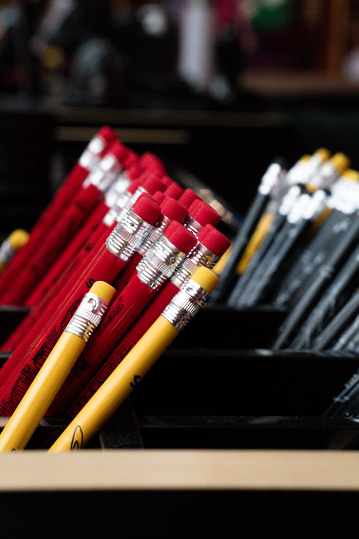 gallery-5 Close-up of red and yellow pencils in containers, offering vibrant stationery organization inspiration.
